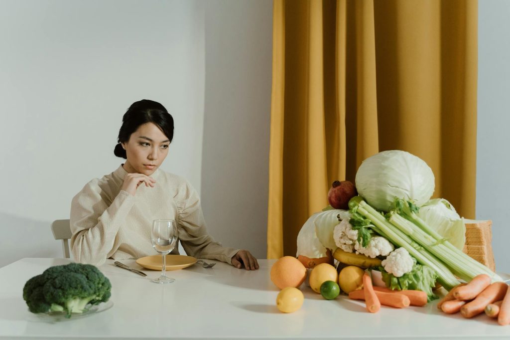 a woman looking at assorted vegetables