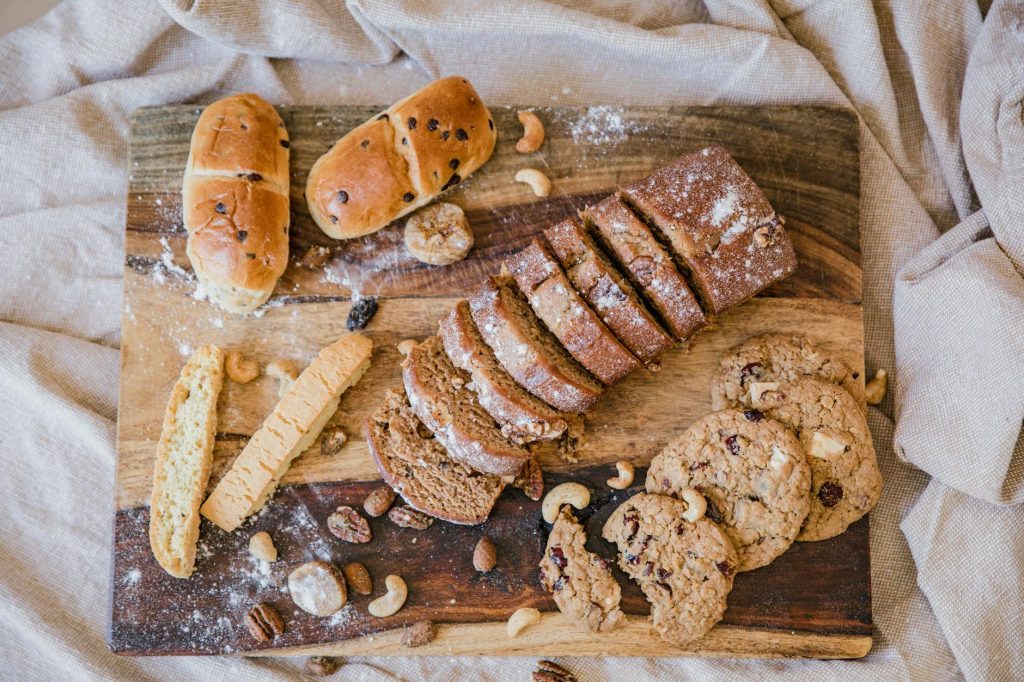 cookies and sliced bread on brown wooden chopping board